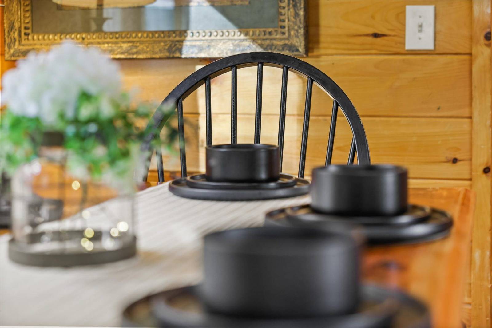 Black chair and place settings on a table with wood paneling