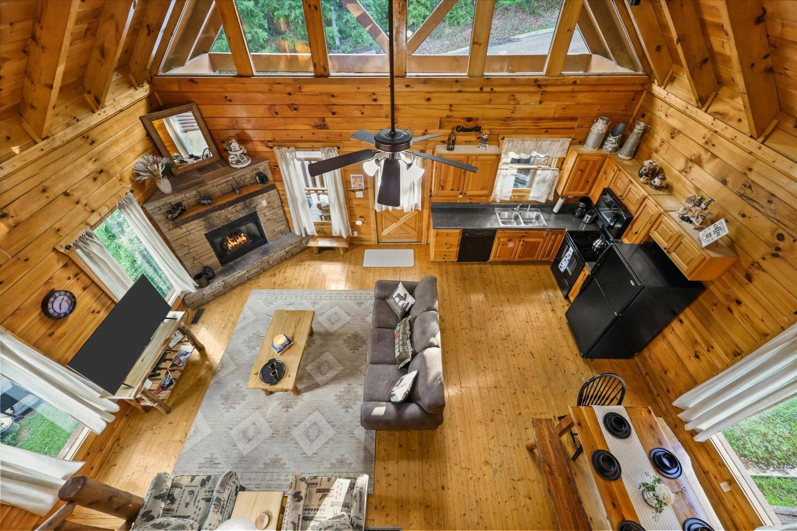 Cozy great room with fireplace, kitchen, and dining area