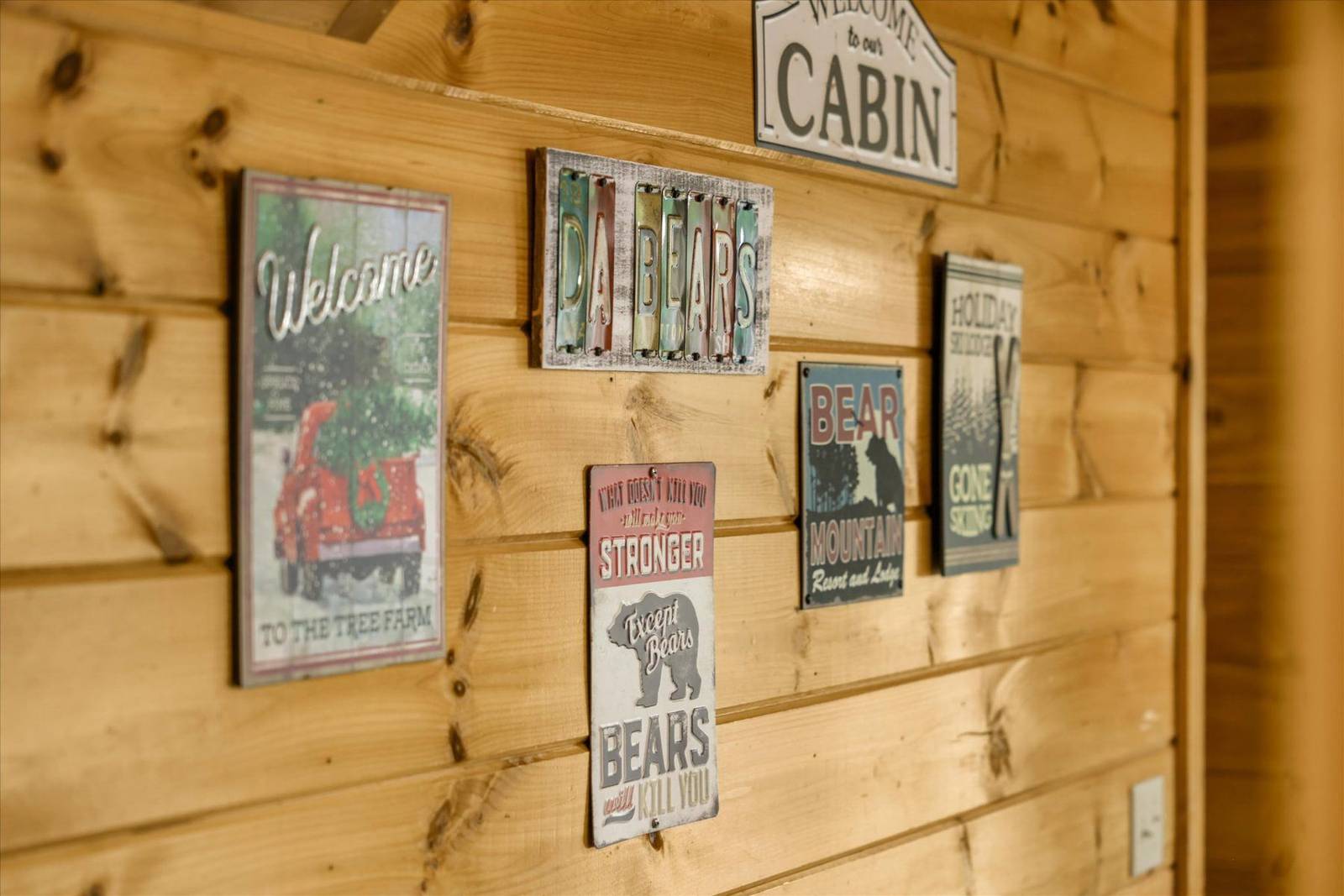 Various rustic signs on a natural wood plank wall